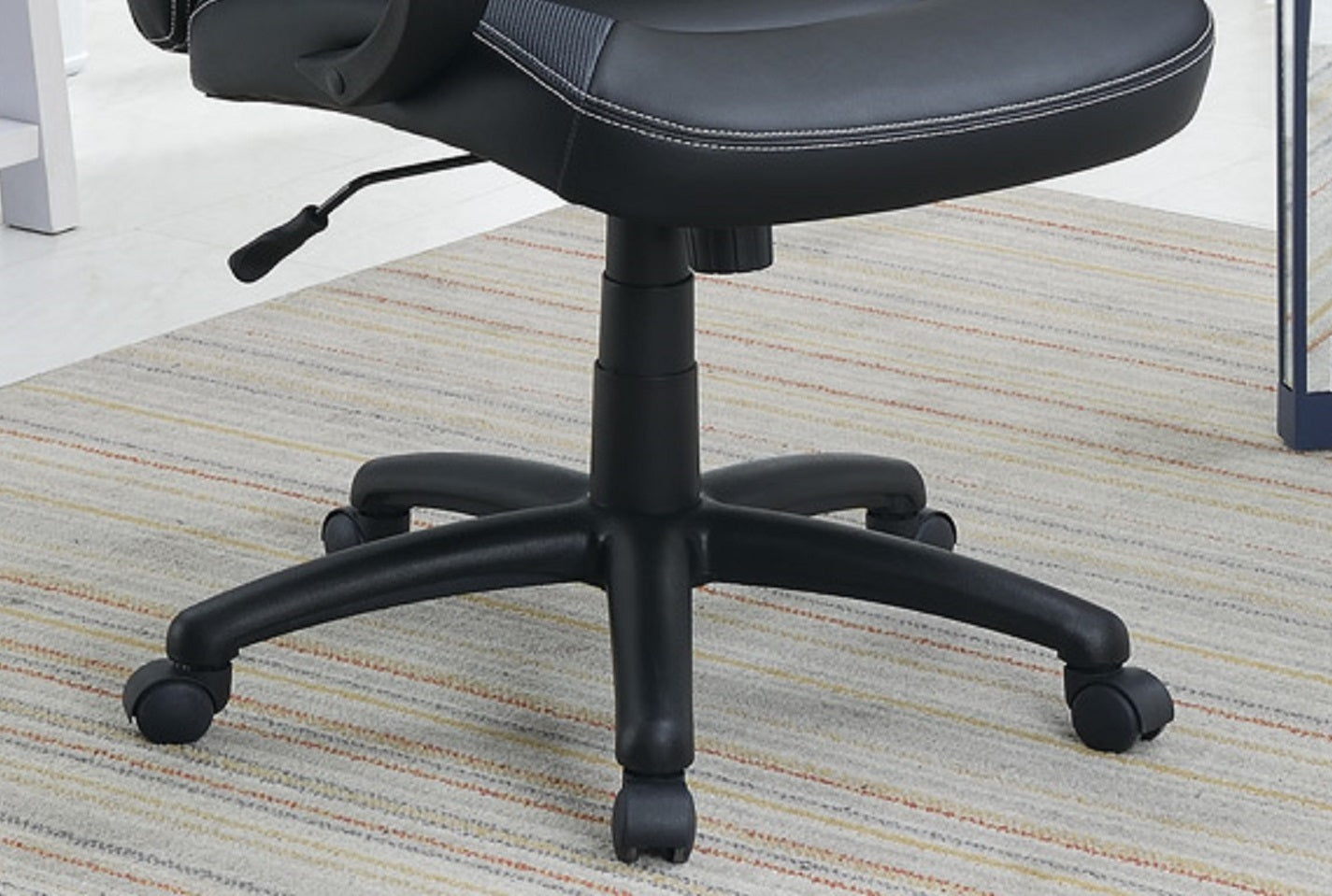 Black office chair with adjustable height lever and fivestar base on casters