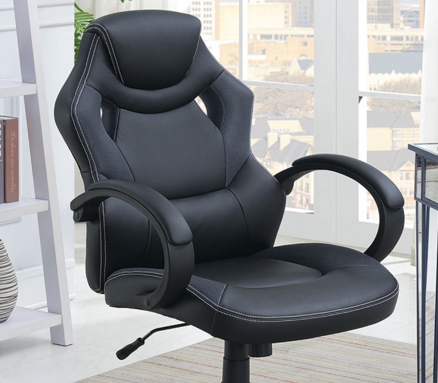 Ergonomic black faux leather office chair with white stitching detail and grey mesh accents