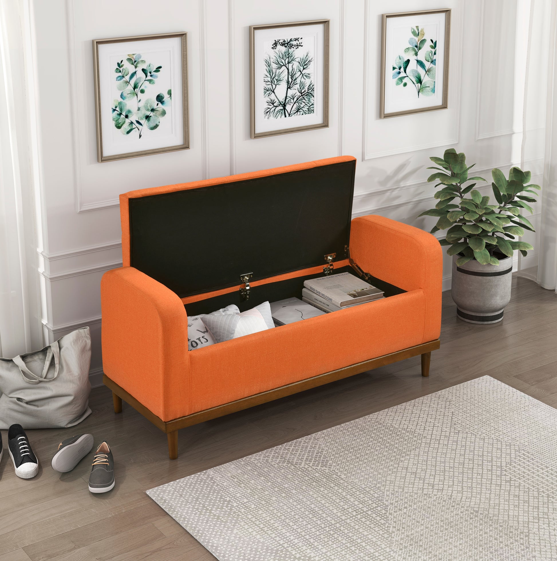 Orange linen storage bench with open lid revealing pillows and books