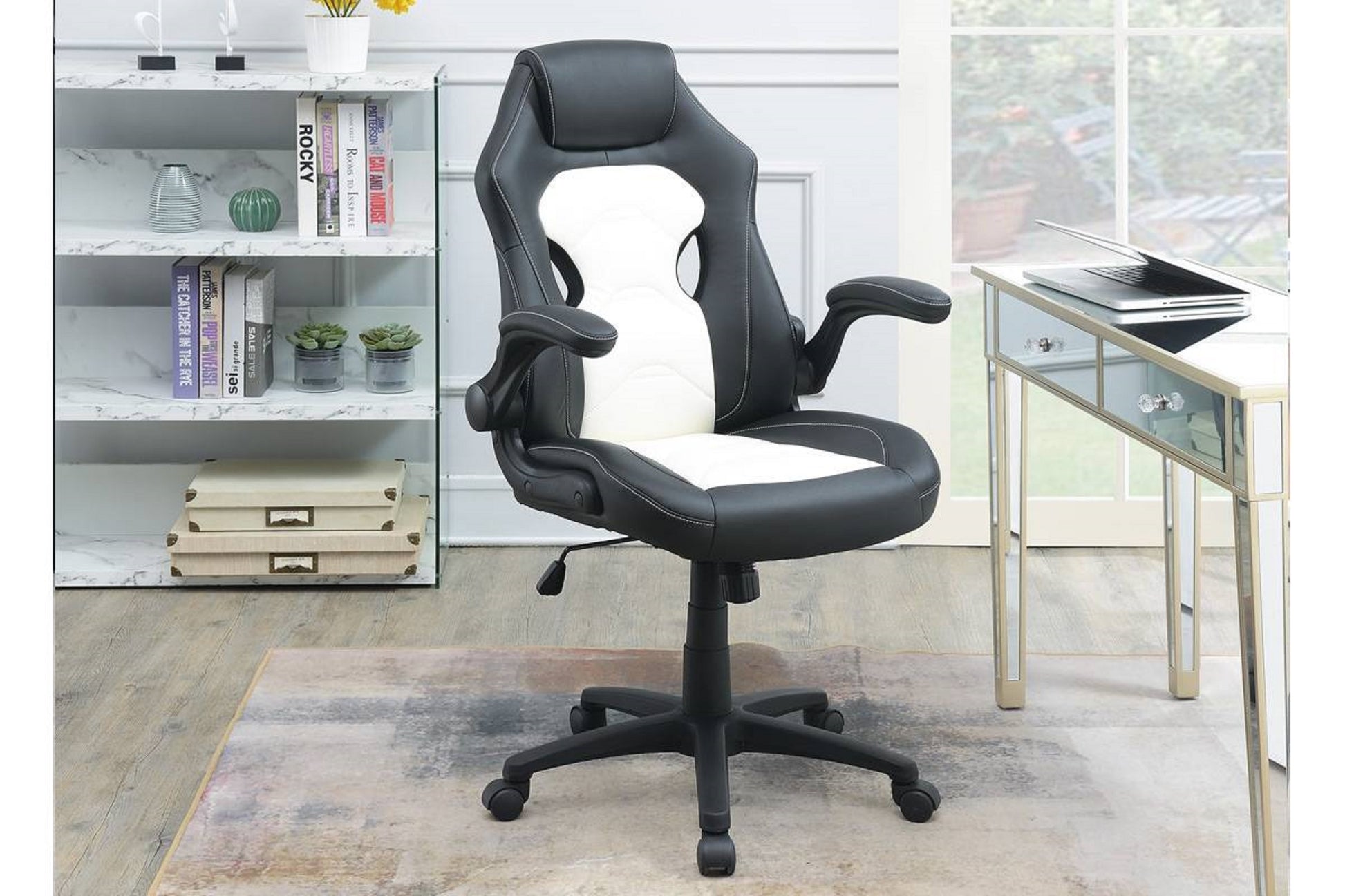 Black and white ergonomic gaming chair with adjustable armrests and lumbar support