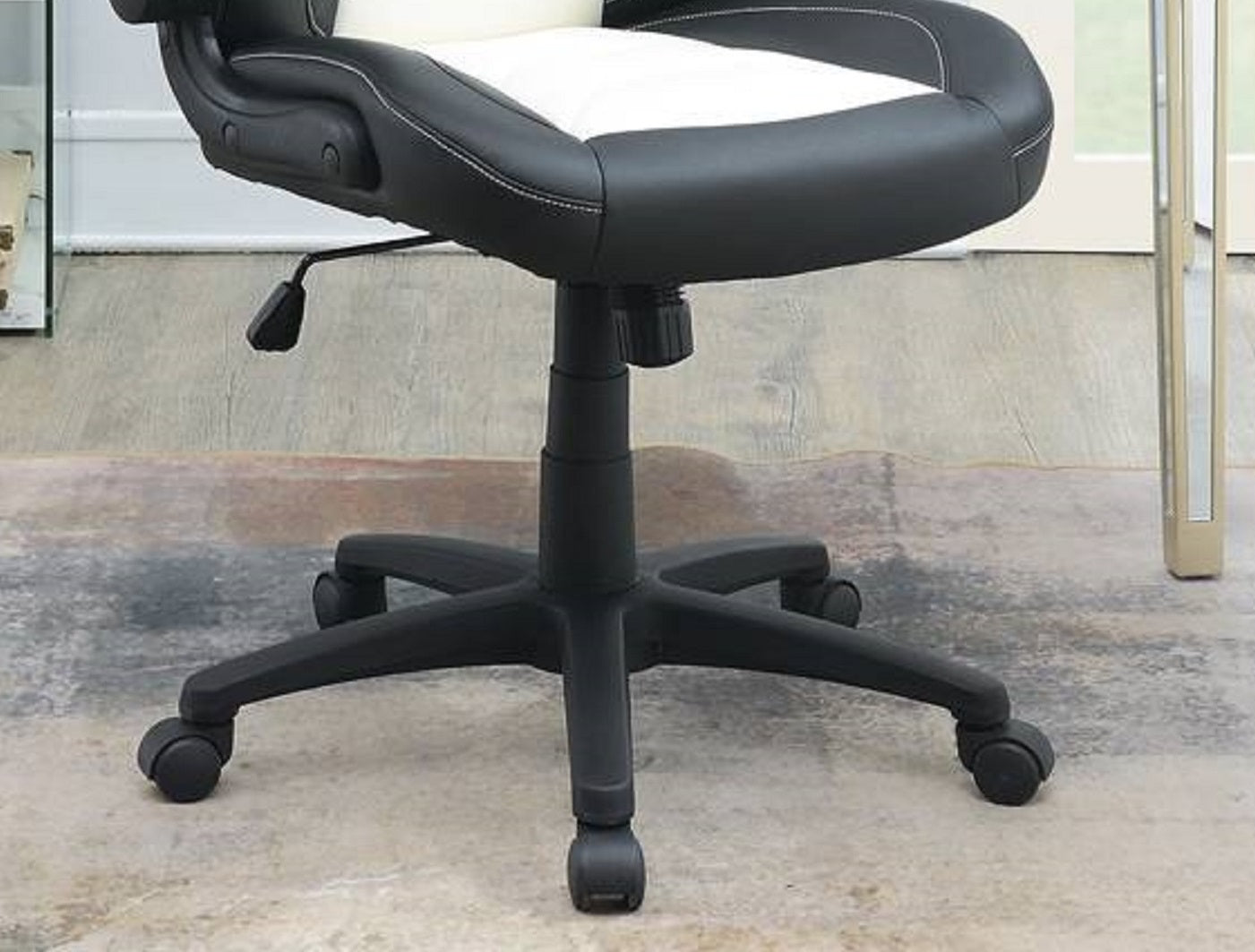 Black and white executive chair with adjustable height and casters