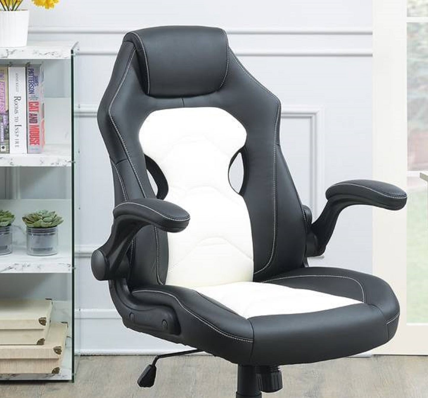 Black and white ergonomic gaming chair with adjustable armrests for comfort
