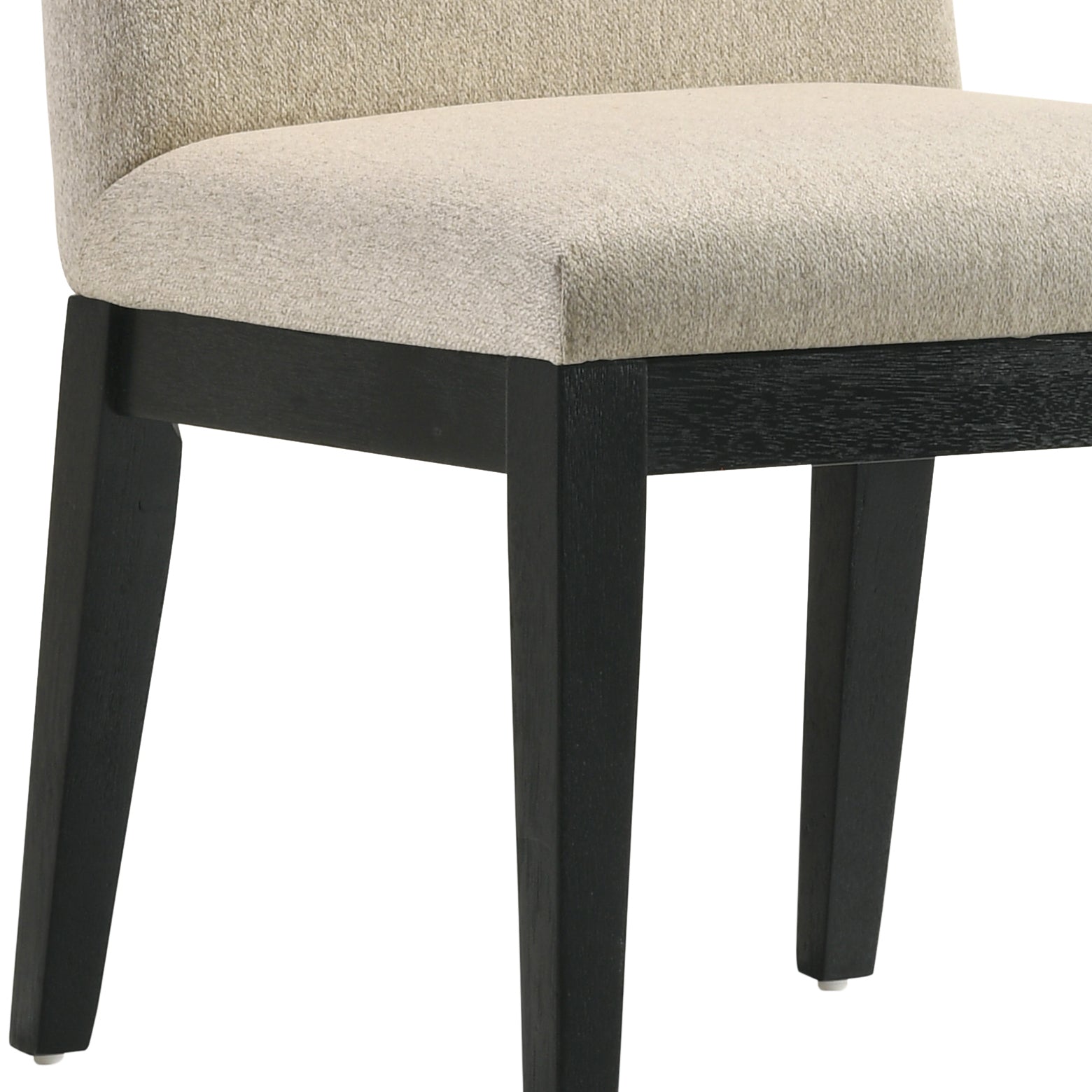 Closeup of a beige upholstered dining chair with dark wood legs