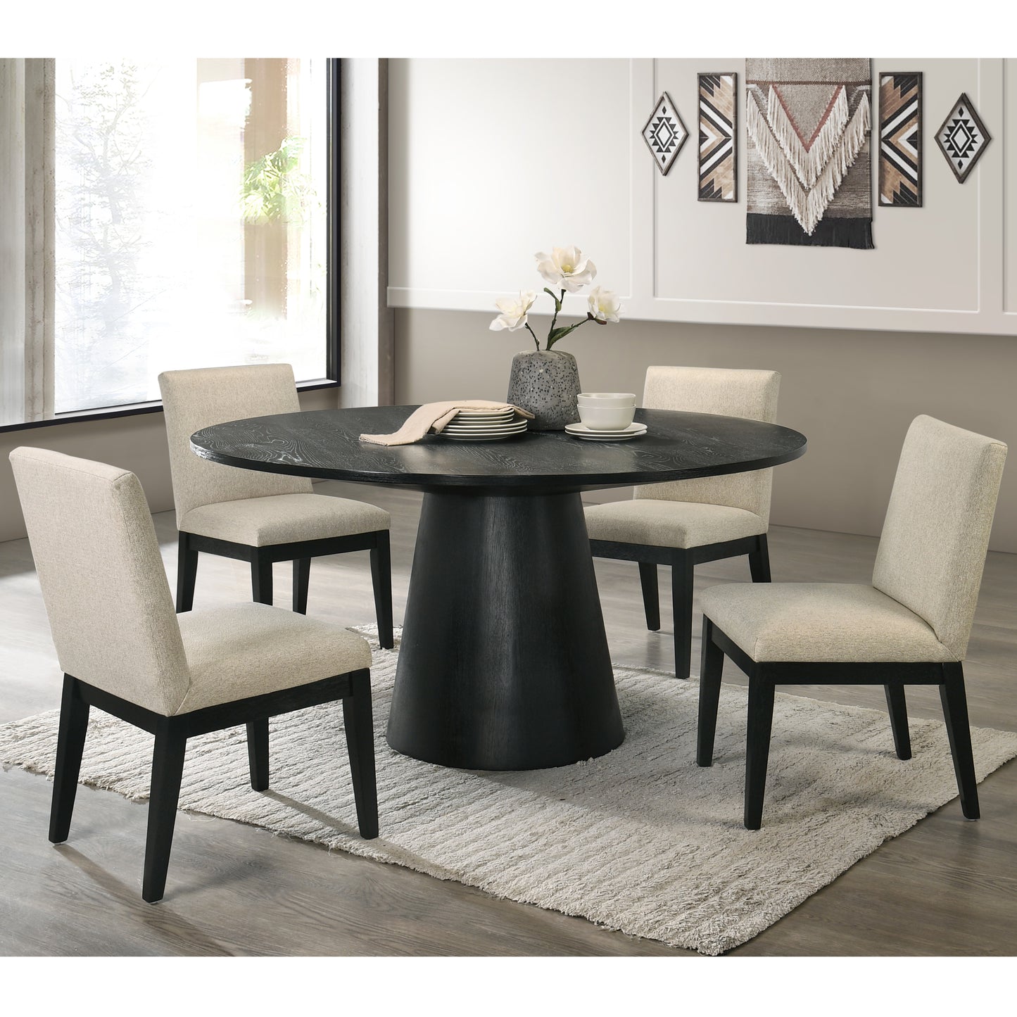 Round black wood dining table with textured dark wood grain and four cream upholstered chairs