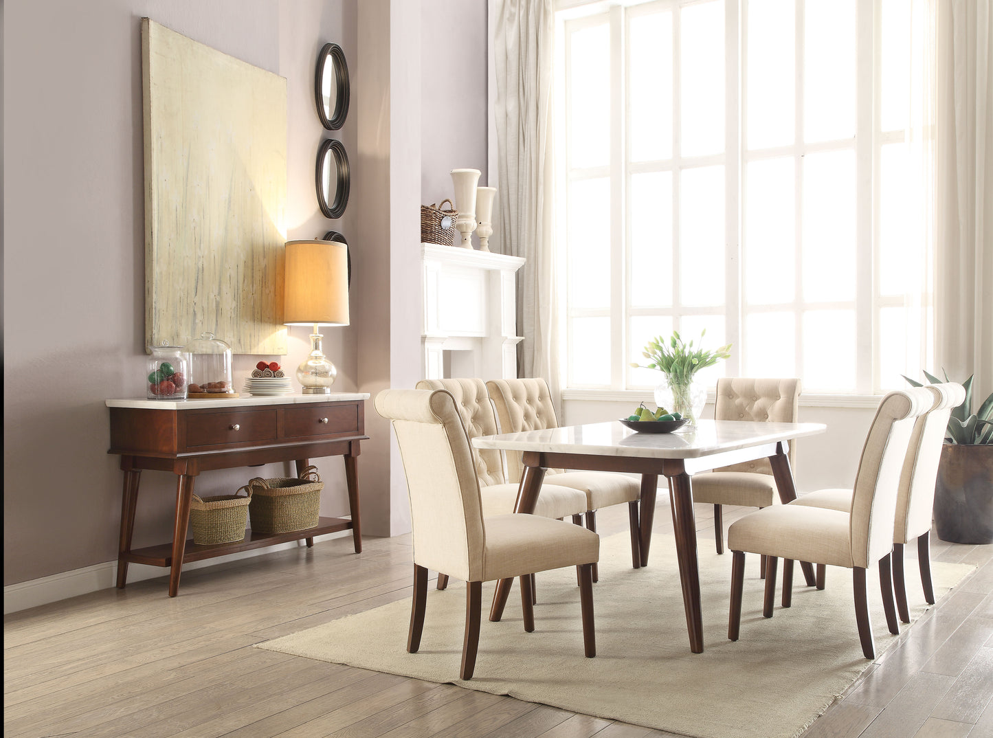 Beige upholstered dining chairs with tufted backs surrounding a marbletop dining table