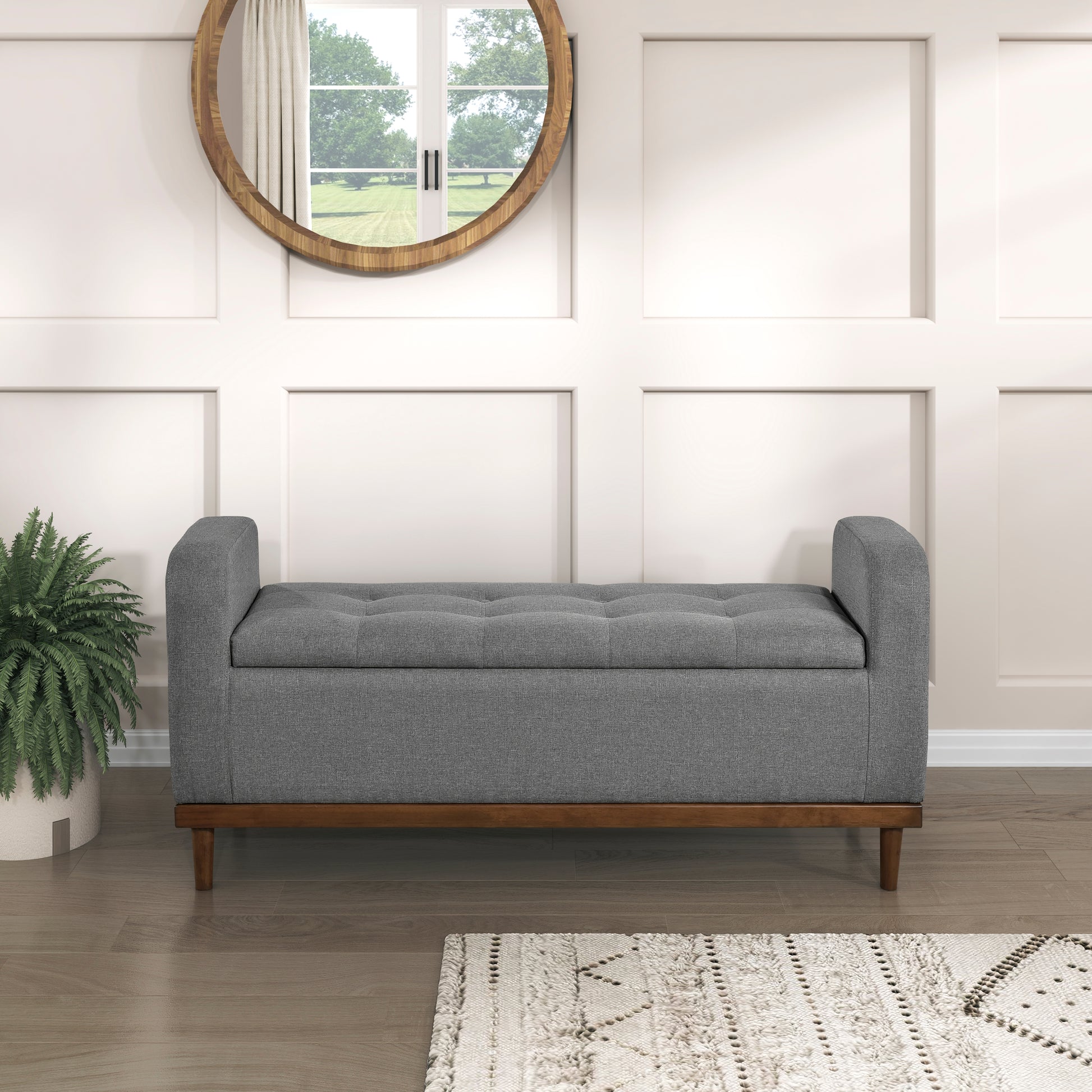 Grey fabric storage bench with tufted lid and wooden legs