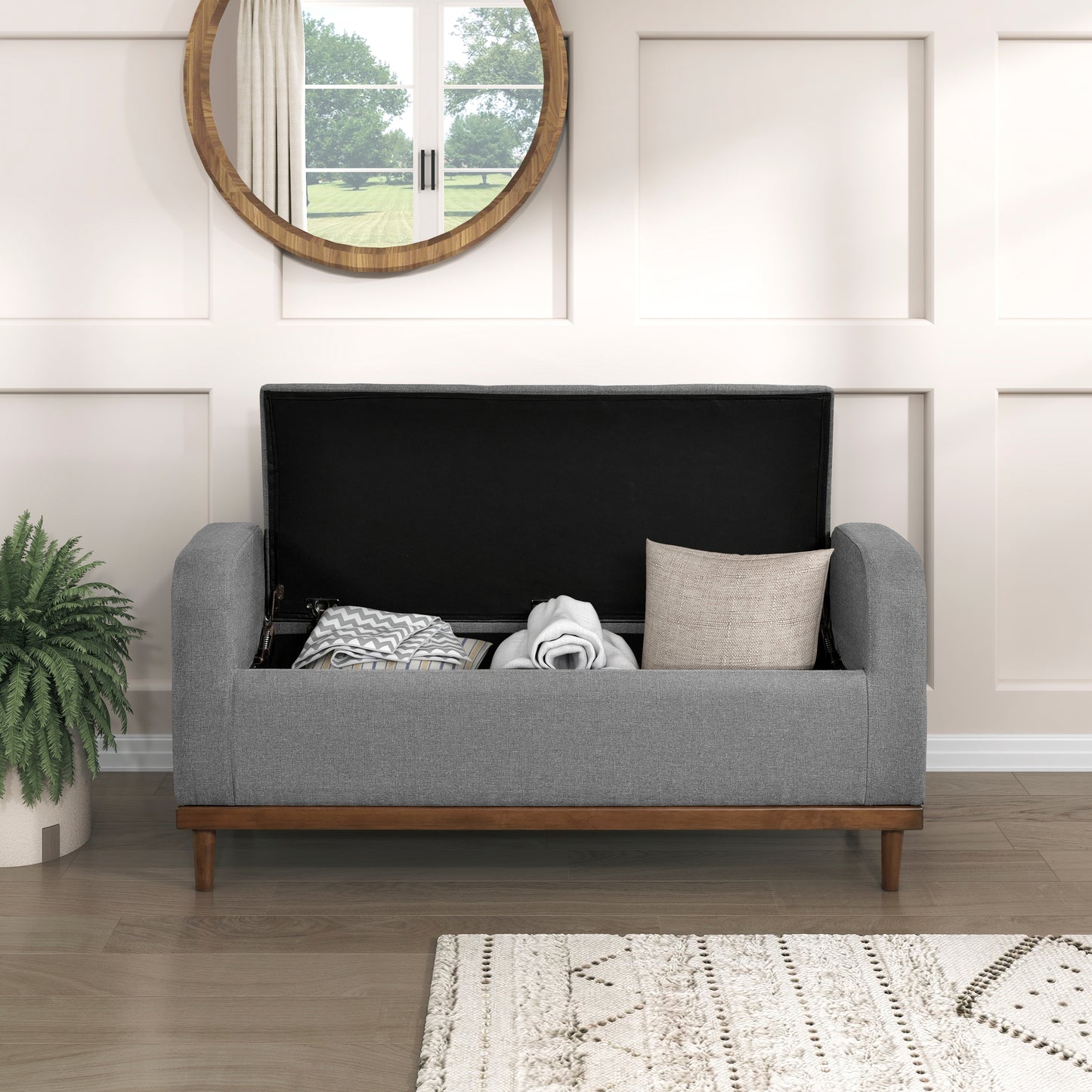 Gray fabric storage bench with open lid revealing blankets