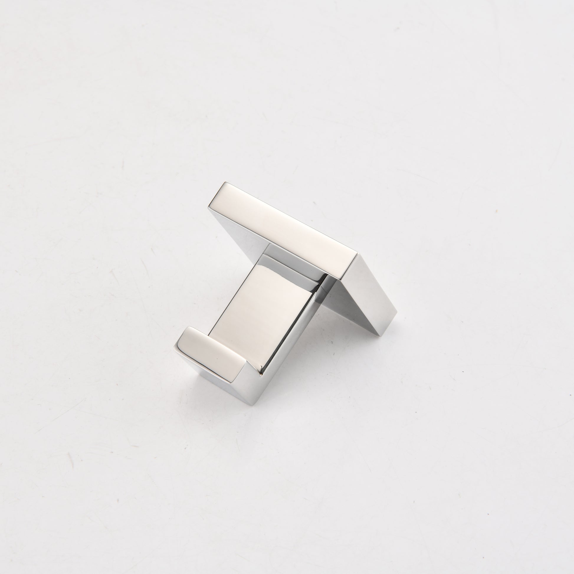 Sleek chrome wall hook with a minimalist modern design for bathroom organization