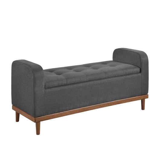 Dark grey tufted storage bench with wood frame and tapered legs