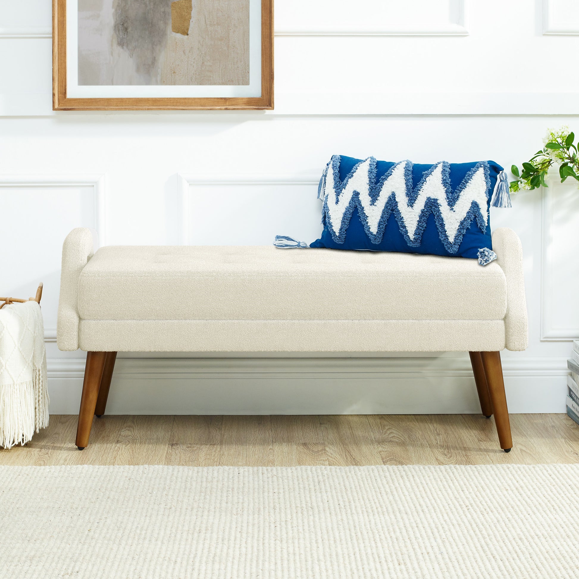 Cream upholstered bench with tufted seat and wooden legs