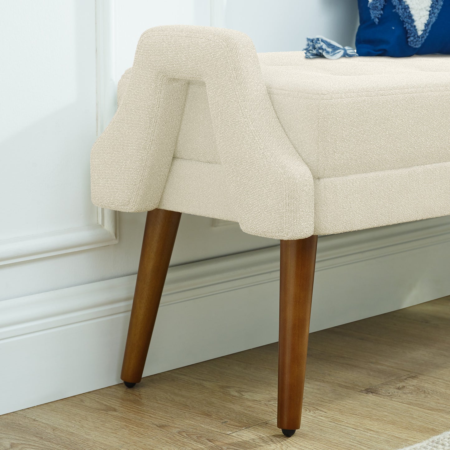 Cream boucle upholstered bench with tapered wooden legs