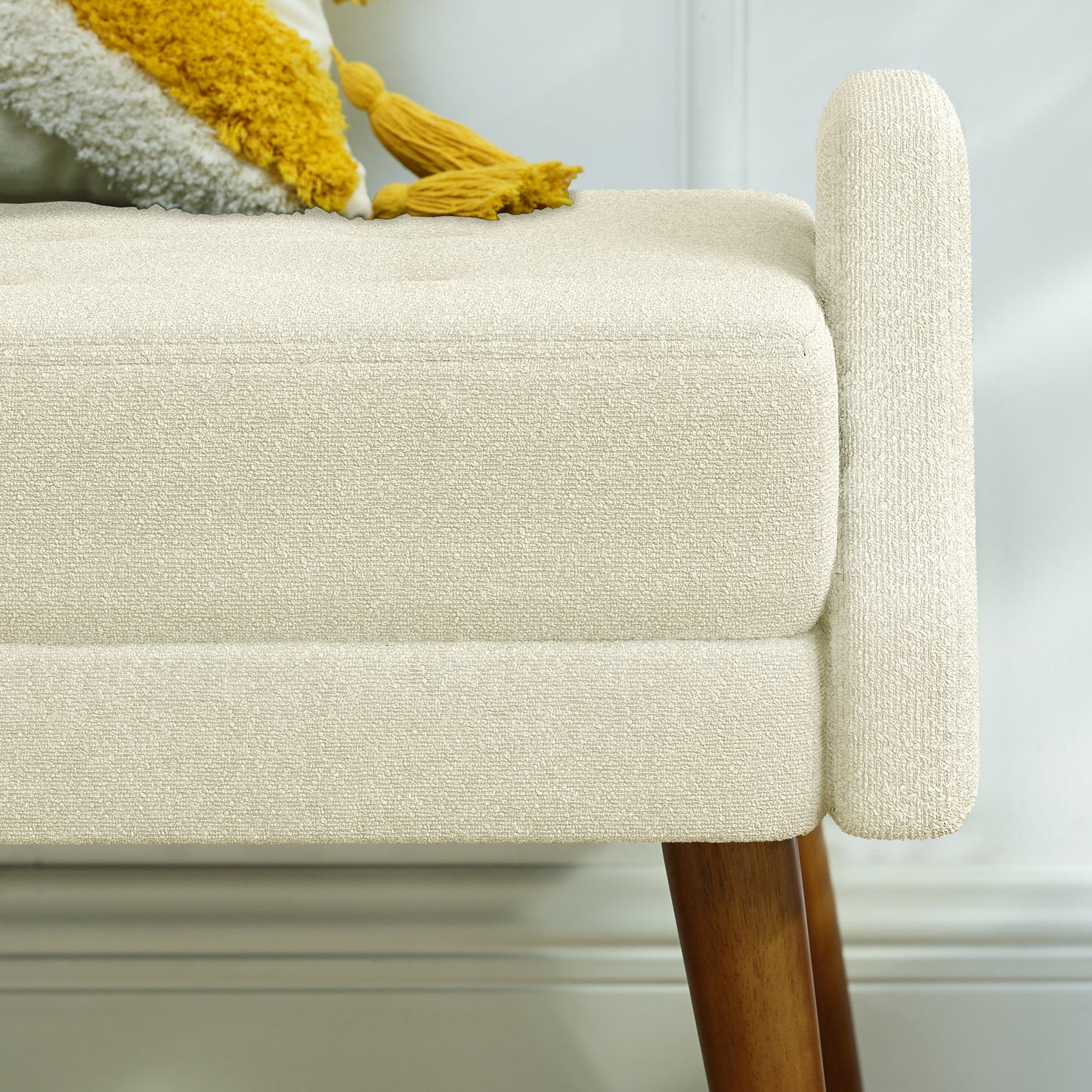 Cream textured fabric bench with tufted seat and wooden legs