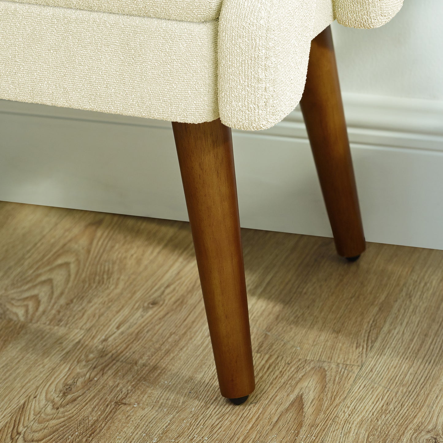 Cream textured armchair with tapered wooden legs