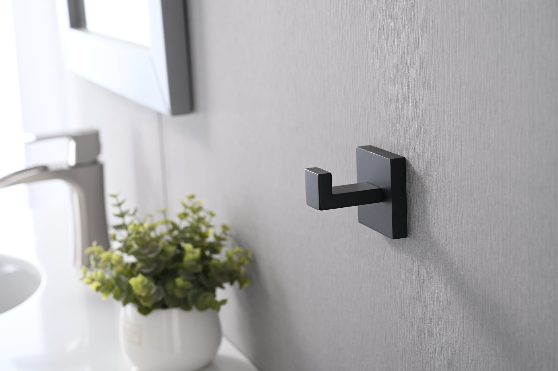 Modern black metal wall hook with a square base perfect for bathrooms