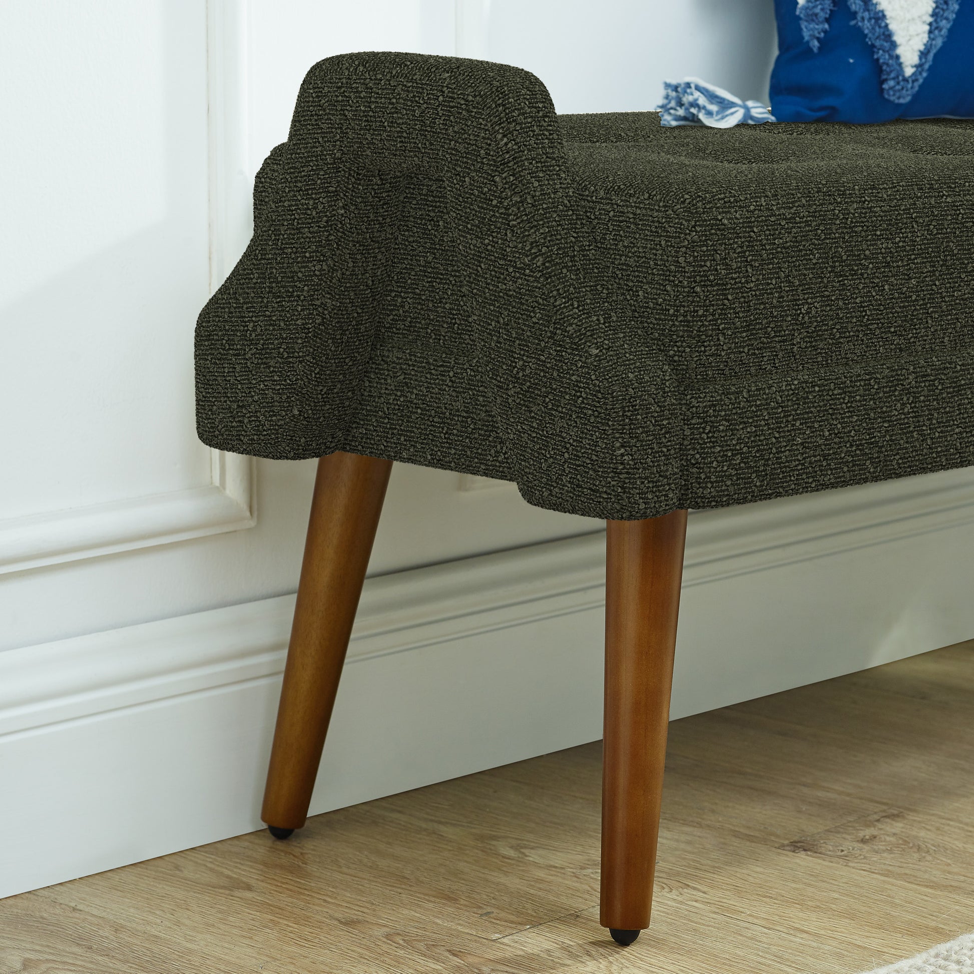Textured dark gray upholstered bench with tapered wooden legs