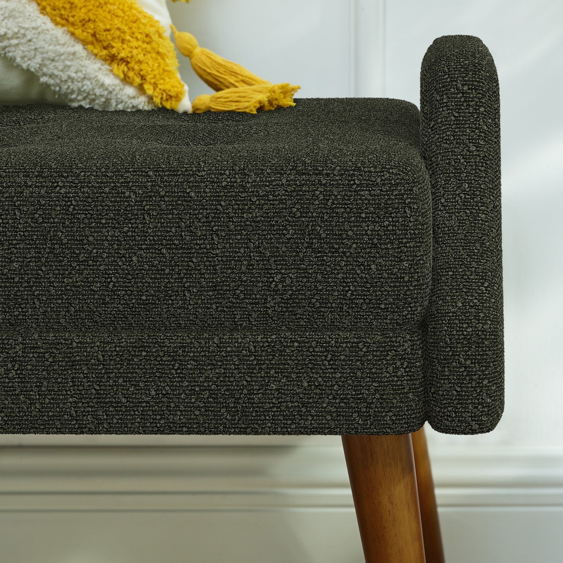 Dark gray boucle upholstered bench with wood legs