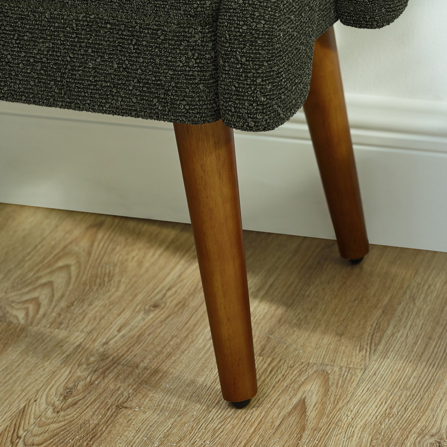 Textured charcoal fabric upholstery on a midcentury modern accent chair