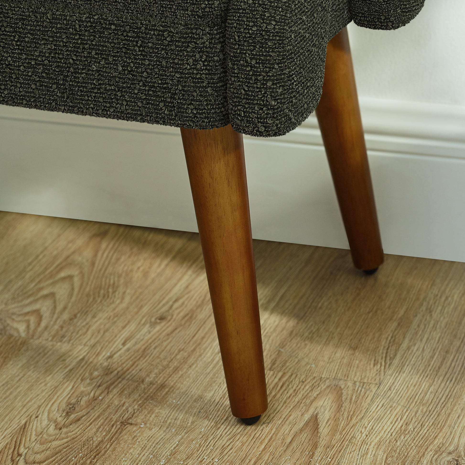 Textured charcoal fabric upholstery on a midcentury modern accent chair