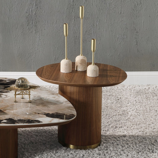 Set of three modern brass and stone candle holders on a wooden table