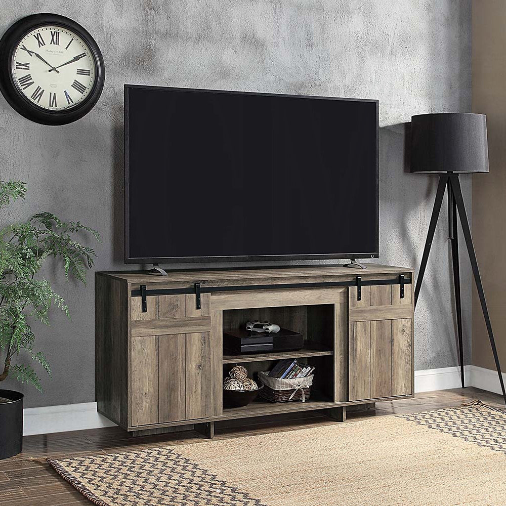 Rustic gray wood TV stand with sliding barn doors and open shelving