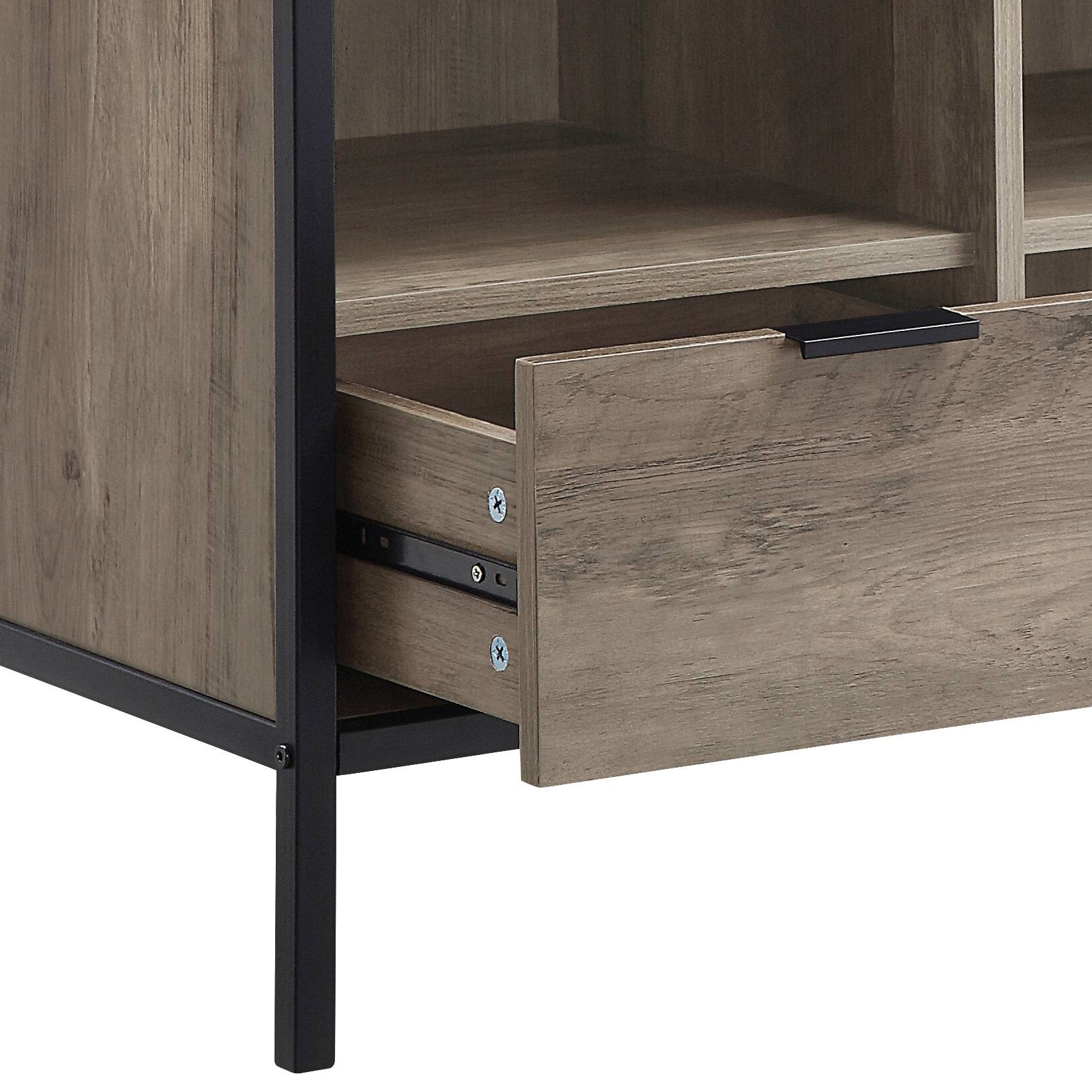 Closeup of distressed wood grain texture on a media console drawer with black metal frame