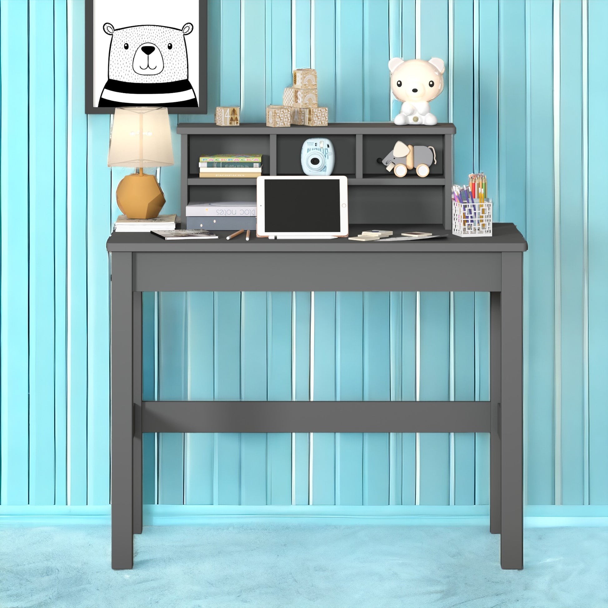 Dark gray wooden desk with tablet lamp and decorative items