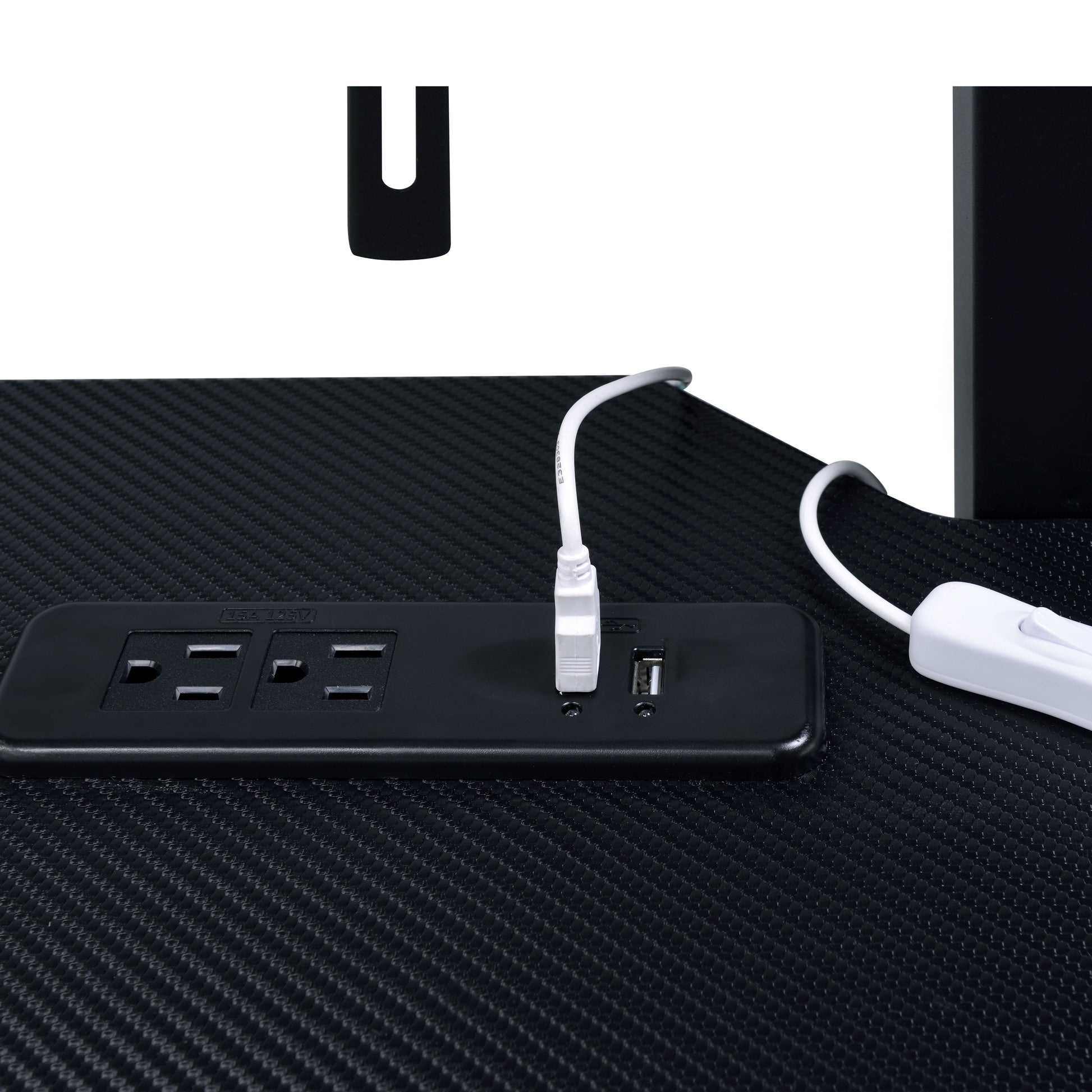 Black carbon fiber texture desk with integrated power strip featuring  outlets and USB ports