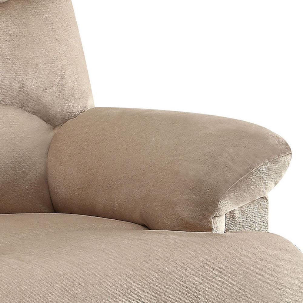 Closeup of a plush beige armchair armrest tufted detail visible