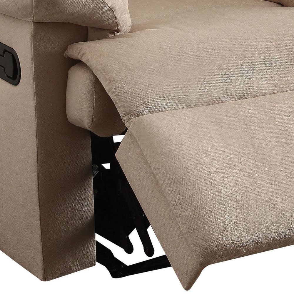 Closeup of beige fabric recliner lever and mechanism with footrest partially extended