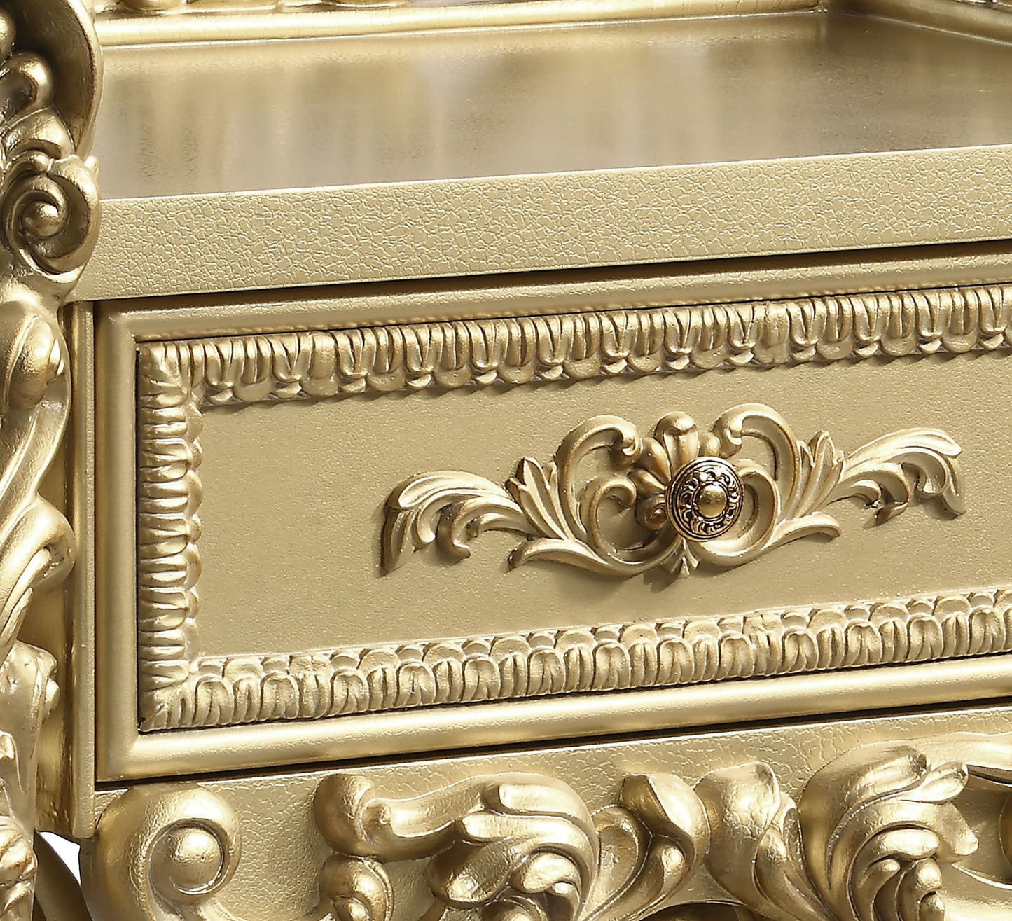 Ornate gold baroque dresser drawer with carved detailing and antique knob