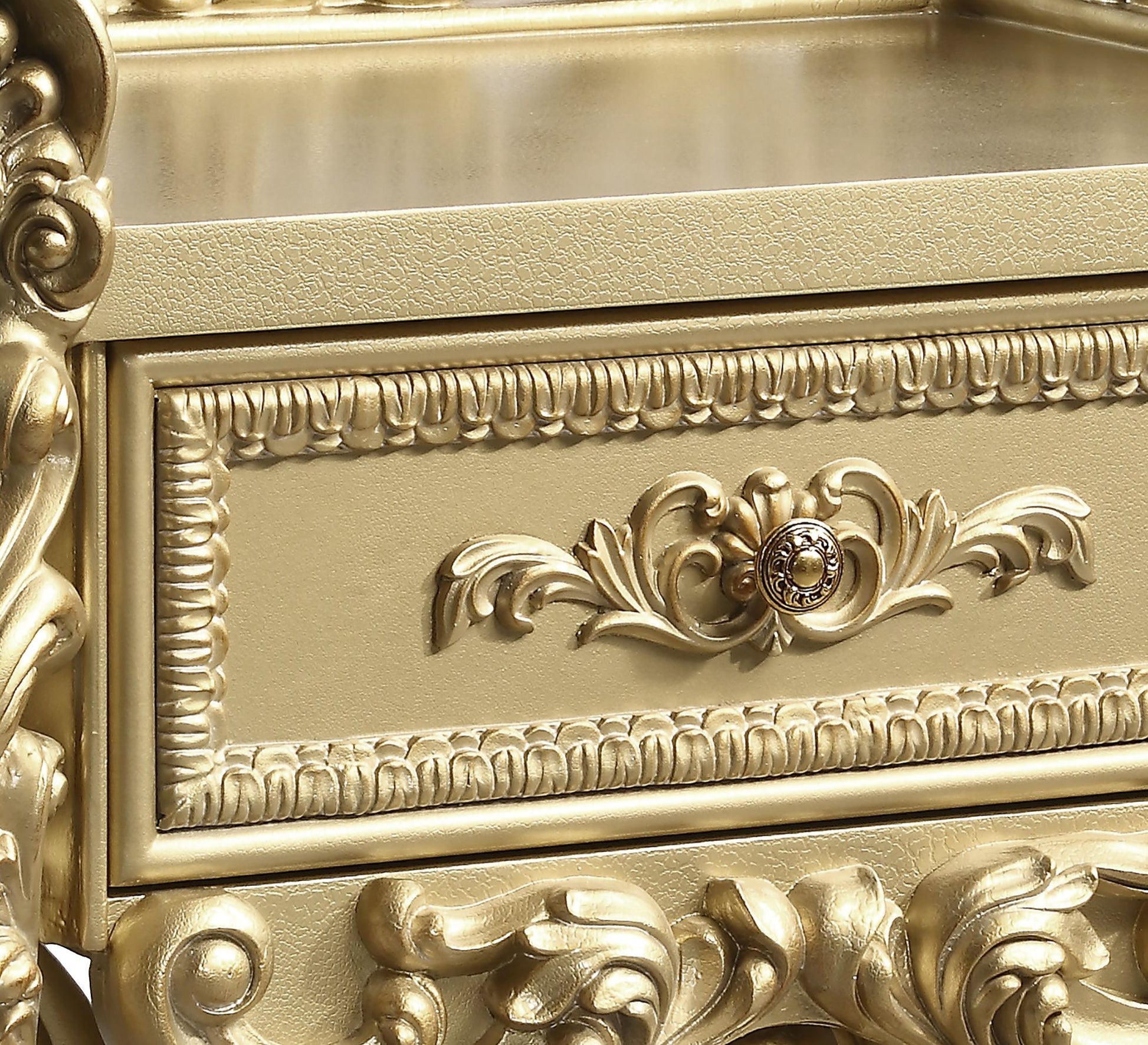 Ornate gold baroque dresser drawer with carved detailing and antique knob