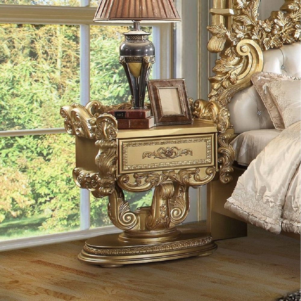 Ornate gold nightstand with intricately carved details featuring one drawer and an oval base