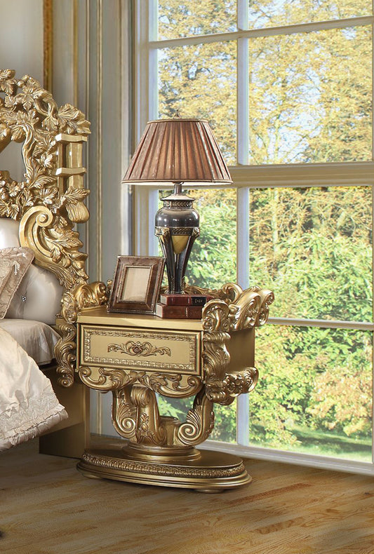 Ornate gold nightstand with ornate drawer pulls and decorative trim complementing a luxury bedroom