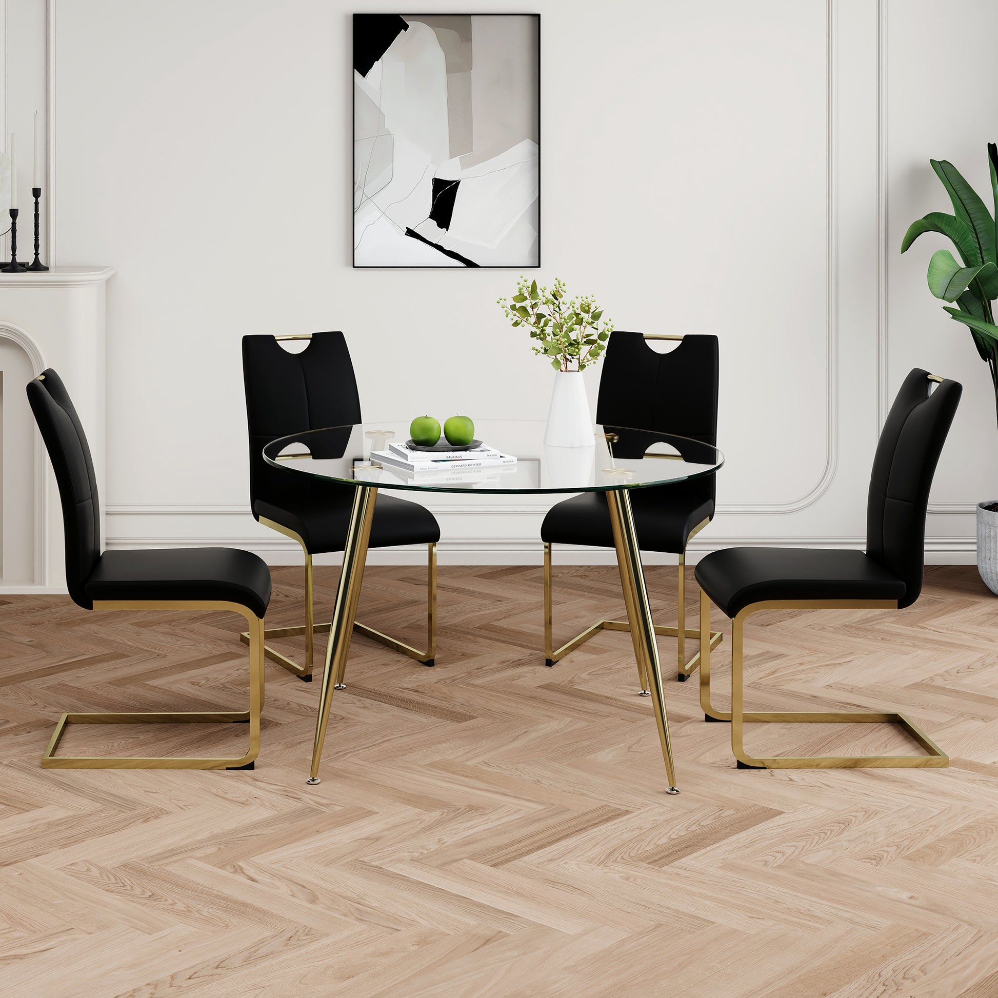 Black velvet dining chairs with gold legs surround a round glass table perfect for modern kitchens