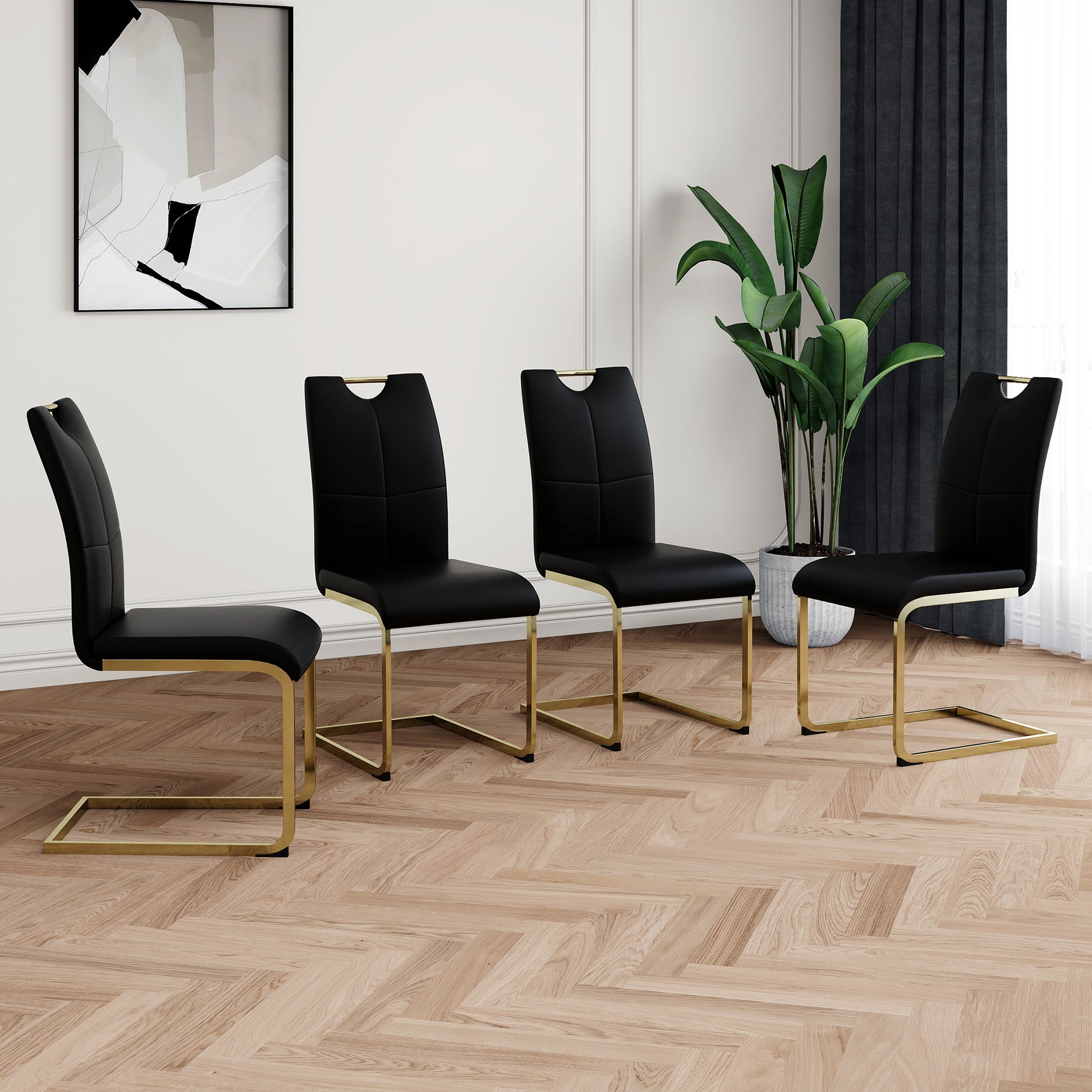 Set of  black faux leather dining chairs with gold Ushaped legs and cutout handles