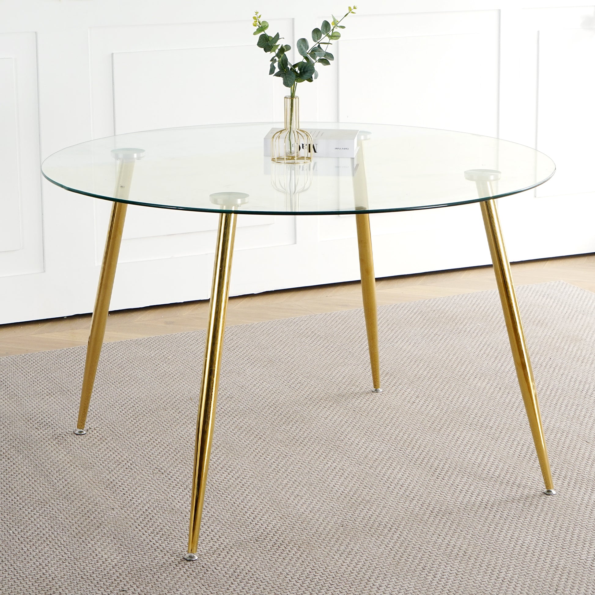 Round glass dining table with sleek gold hairpin legs perfect for modern kitchens