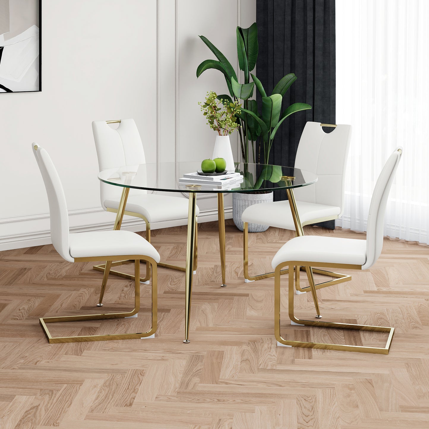 Round glass dining table with white upholstered chairs and gold legs