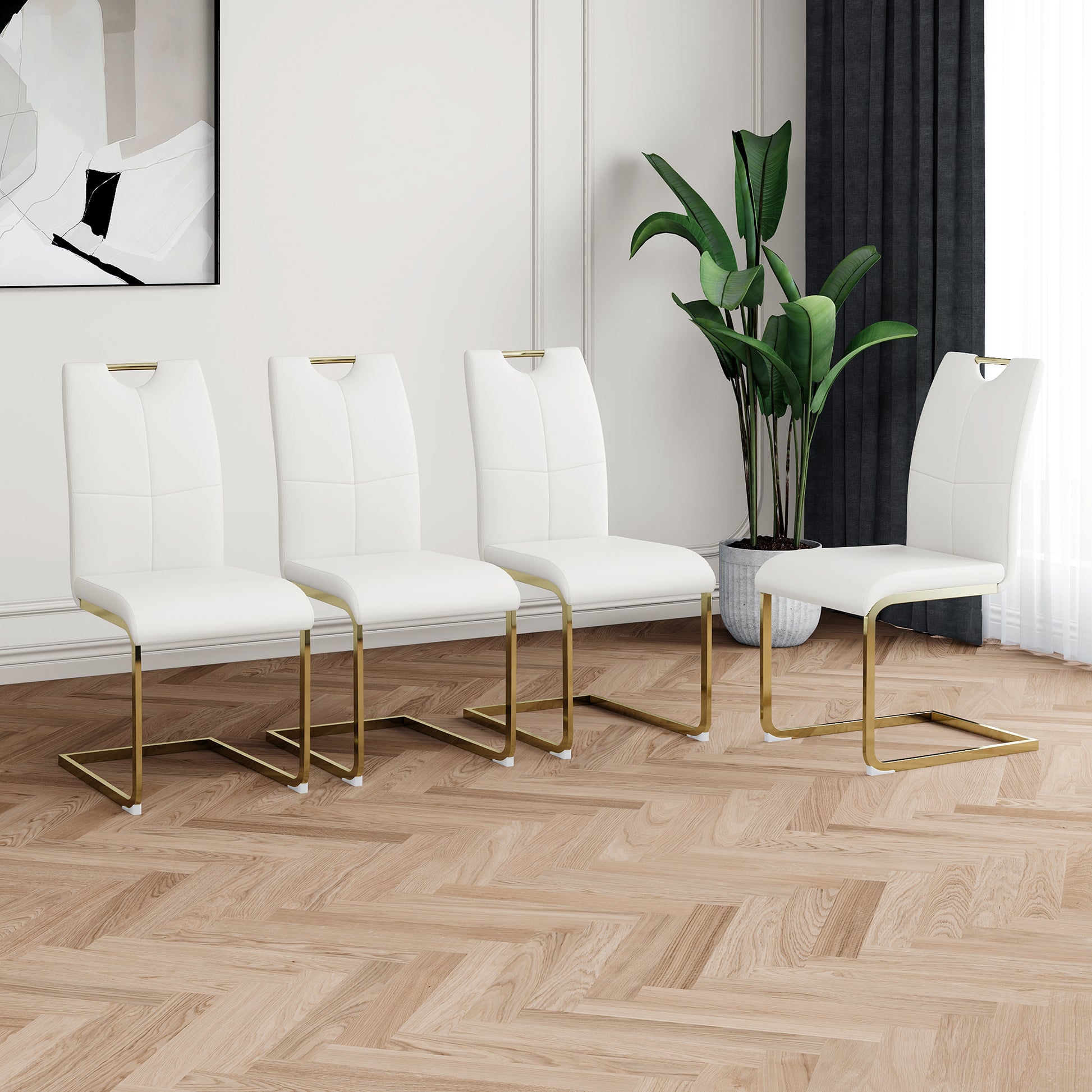 Four white faux leather dining chairs with gold sled legs modern design