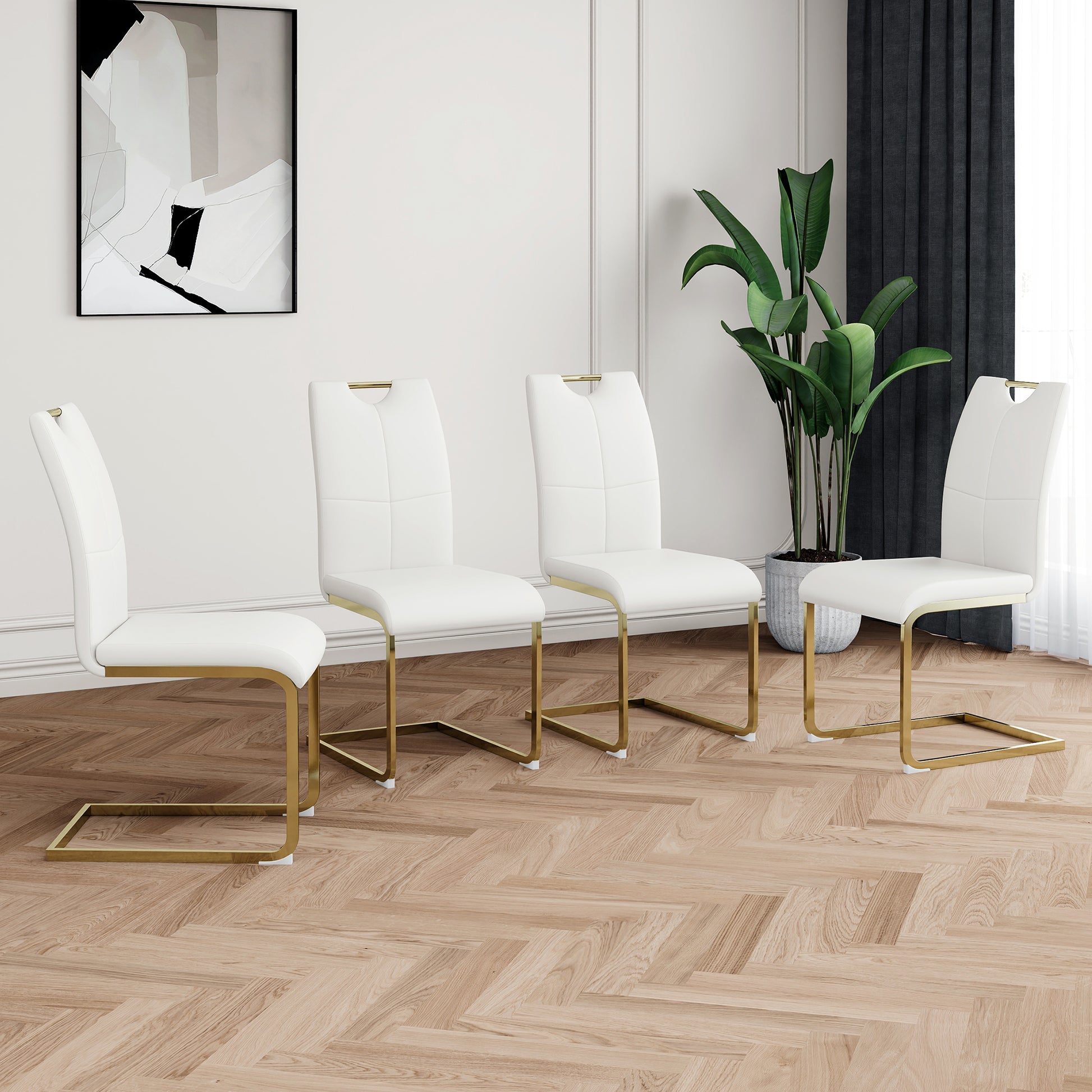 Set of four modern white faux leather dining chairs with gold metal legs and subtle stitching