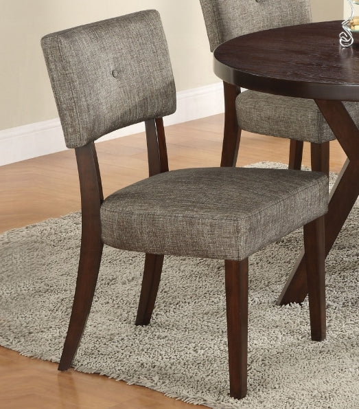 Modern grey upholstered dining chair with button tufted back and dark wood legs