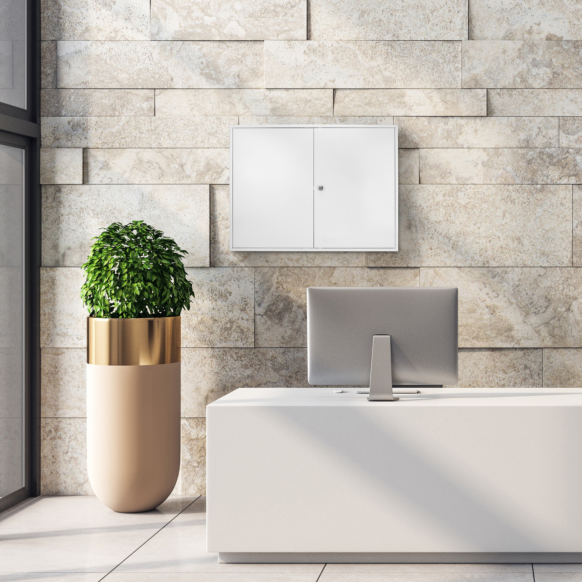 Modern white lockable wall cabinet with a silver lock against a textured stone wall