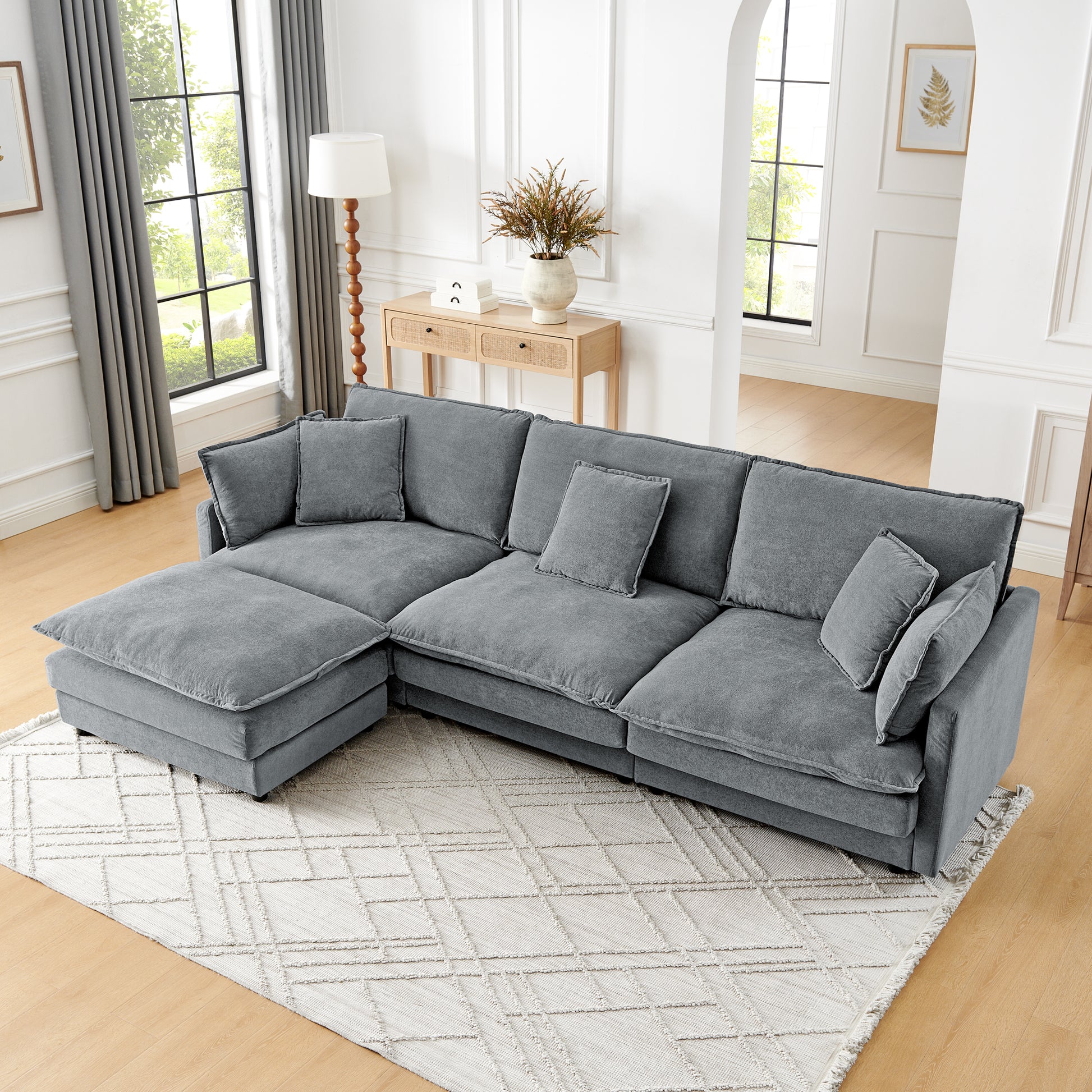 Plush grey fabric sectional sofa with chaise and accent pillows for comfortable living room seating