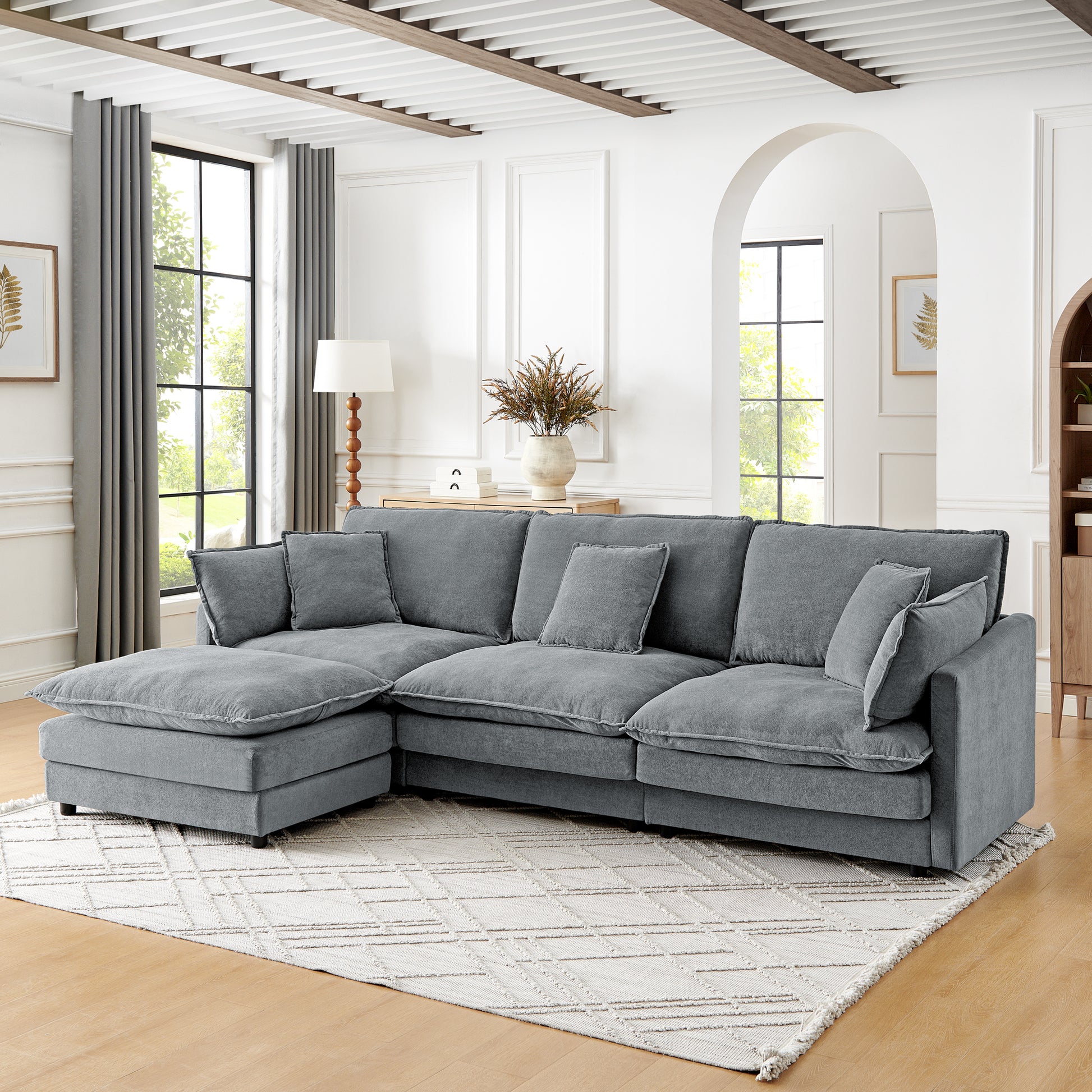 Plush grey sectional sofa with chaise and loose cushions perfect for living room comfort