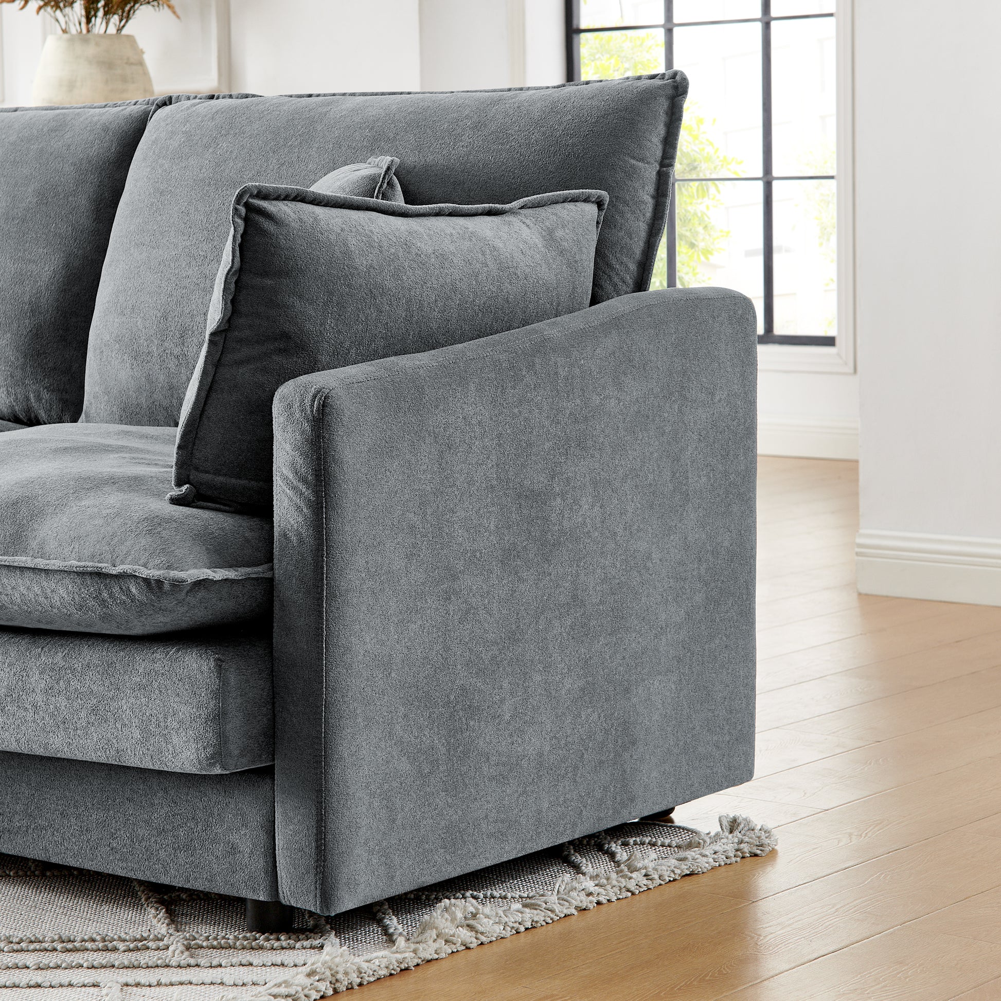 Plush grey fabric sectional sofa with deep seating and textured cushions perfect for modern living rooms
