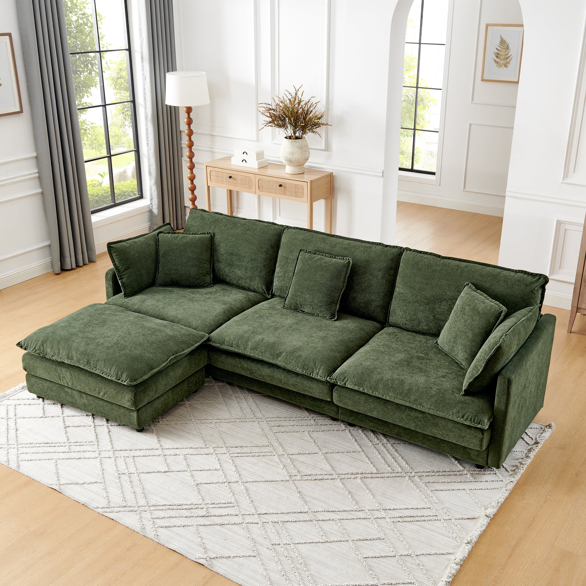 Plush green sectional sofa with chaise lounge and matching accent pillows perfect for modern living rooms