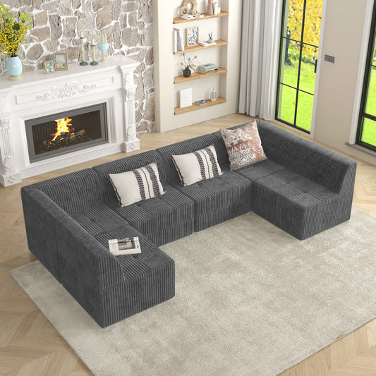 Dark gray corduroy Ushaped sectional sofa with tufted seat cushions and decorative pillows