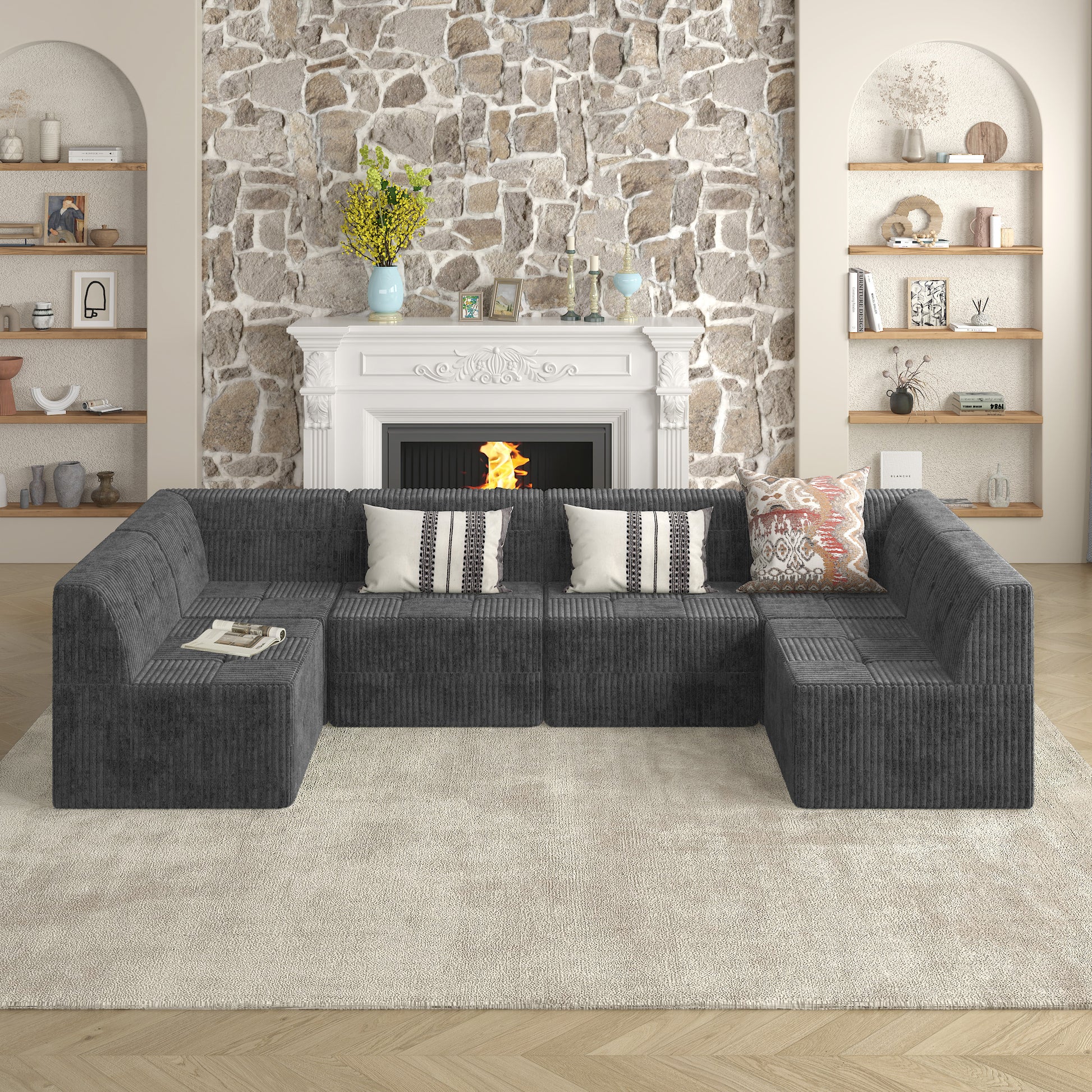 Dark gray corduroy sectional sofa with plush throw pillows and a magazine