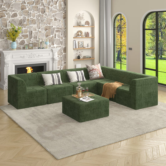 Deep green corduroy sectional sofa with a matching square ottoman creating a cozy living room arrangement