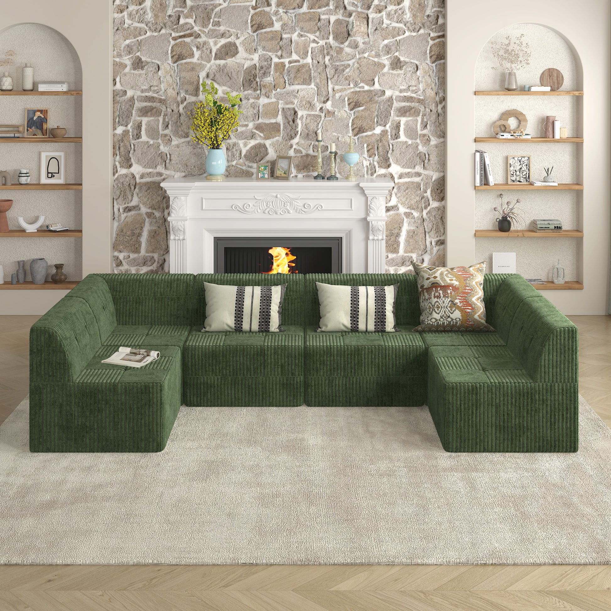 Green corduroy sectional sofa with striped accent pillows on a cream rug