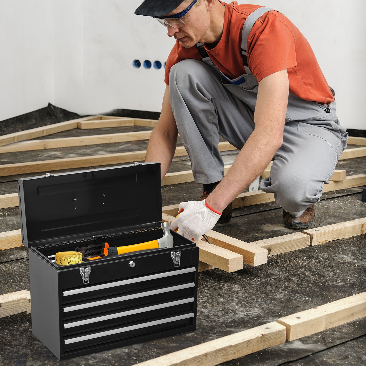 Black metal toolbox with yellow hammer and tape measure inside for home repair